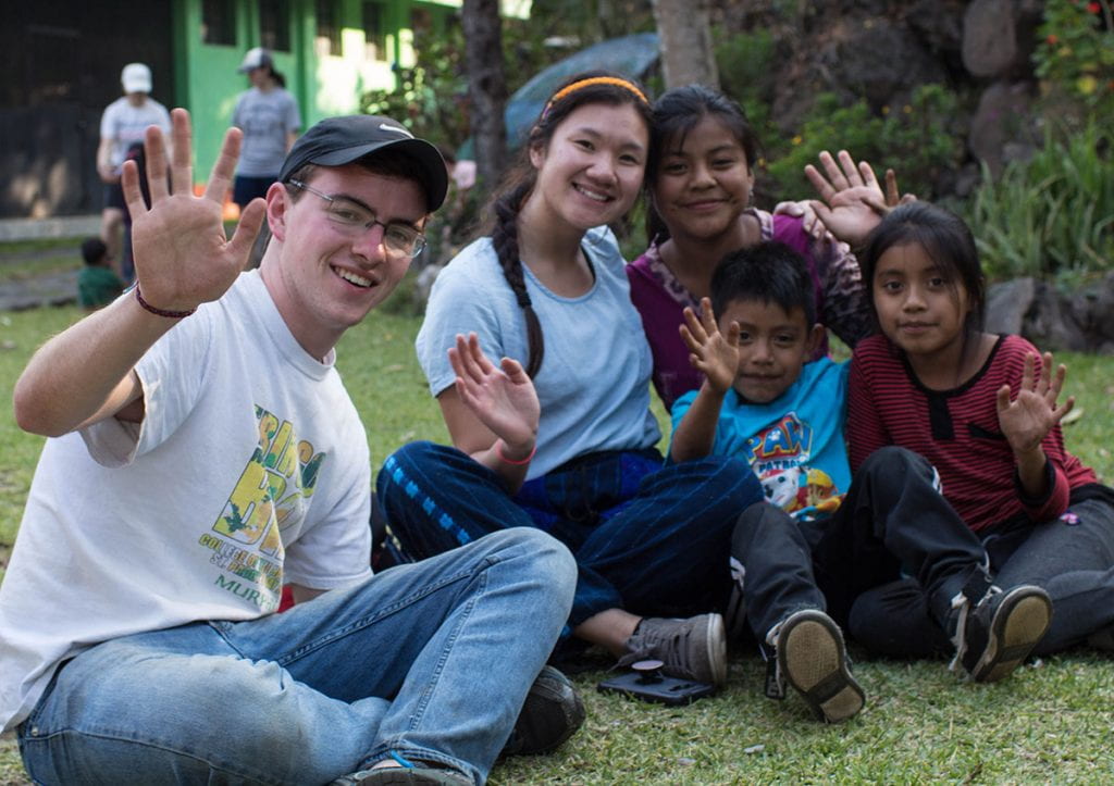 Jack Murphy '20 waves with Providence College students and children in Guatemala.