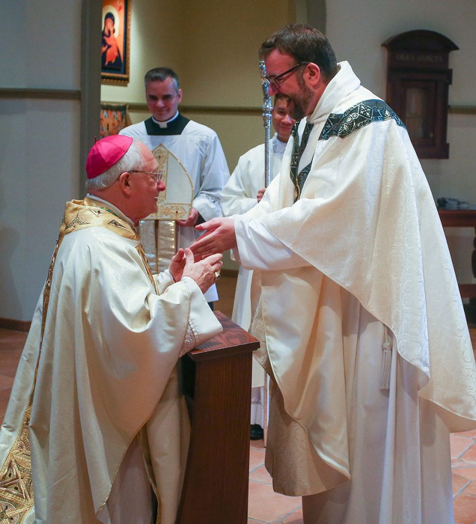 Rev. Jordan Zajac, O.P. '04 is congratulated by Most Rev. Robert C. Evans, auxiliary bishop of Providence.