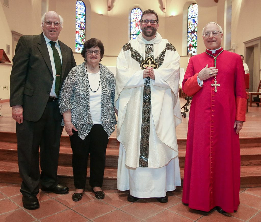 Father Jordan Zajac, O.P. '04 with his parents, Peter and Judith Zajac, and Most Rev. Robert C. Evans, auxiliary bishop of the Diocese of Providence.
