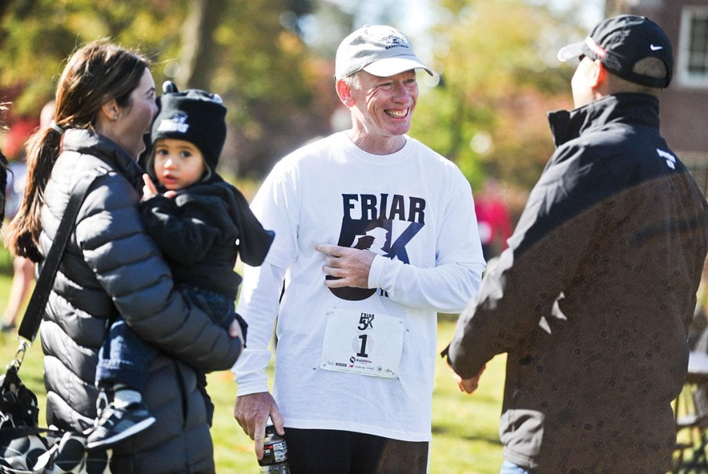 Father Shanley always enjoyed running the annual Friar 5K, a fundraiser for the National Alumni Association Scholarship Fund. He talks after the 2013 with Steve Napolillo '98, his wife, Bethany DeNardo Napolillo, and their son, Drew.