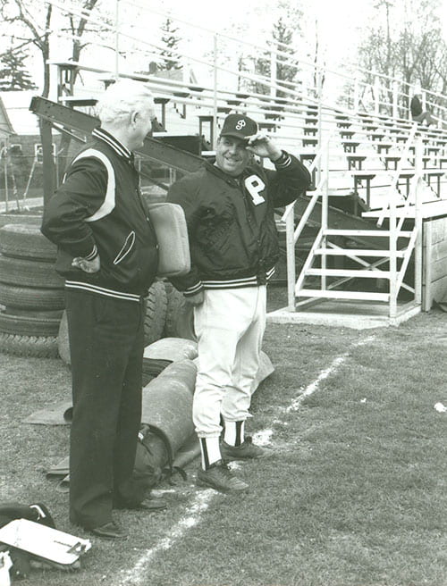 Coach Mezzanotte chats with Rev. James A. Driscoll, O.P. ’49, late theology professor, during a practice.