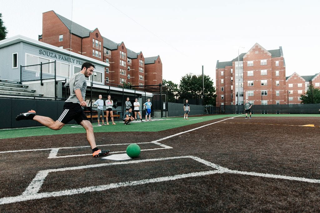 A student takes aim during an intramural kickball game on Glay Field, home of the Providence College softball team.