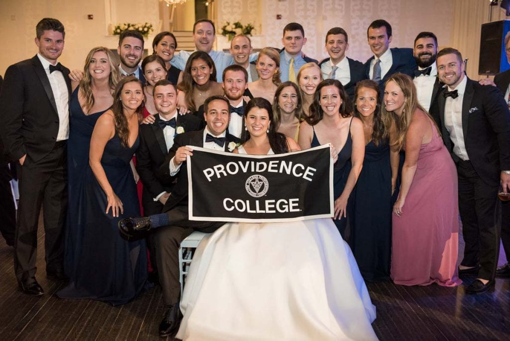 Evan A. Paulson ’14 and Meredith A. Pramer ’15 are surrounded by Friars as they celebrate their wedding.