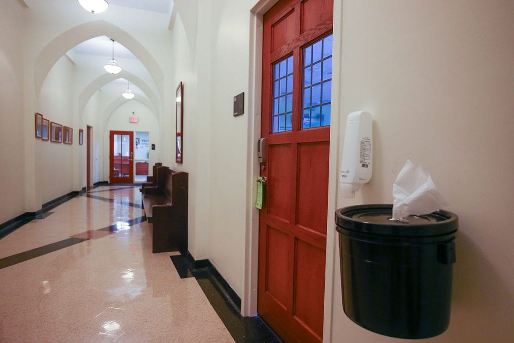 Hand sanitizer and paper towels are available outside a classroom on the third floor of Harkins Hall.