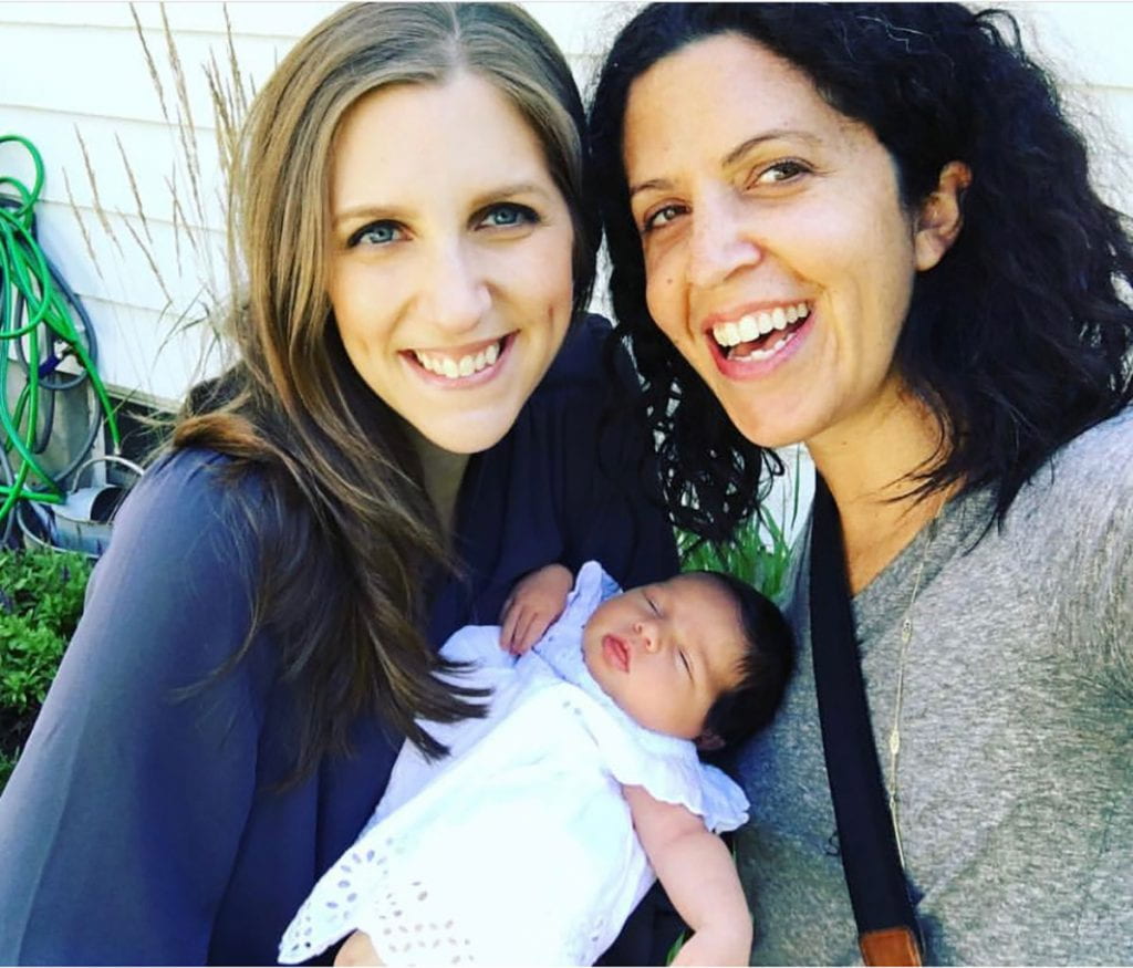 Katie Marra ’02, left, and her newborn daughter, Layla, with Marisa E. McGrody ’02 in 2017
