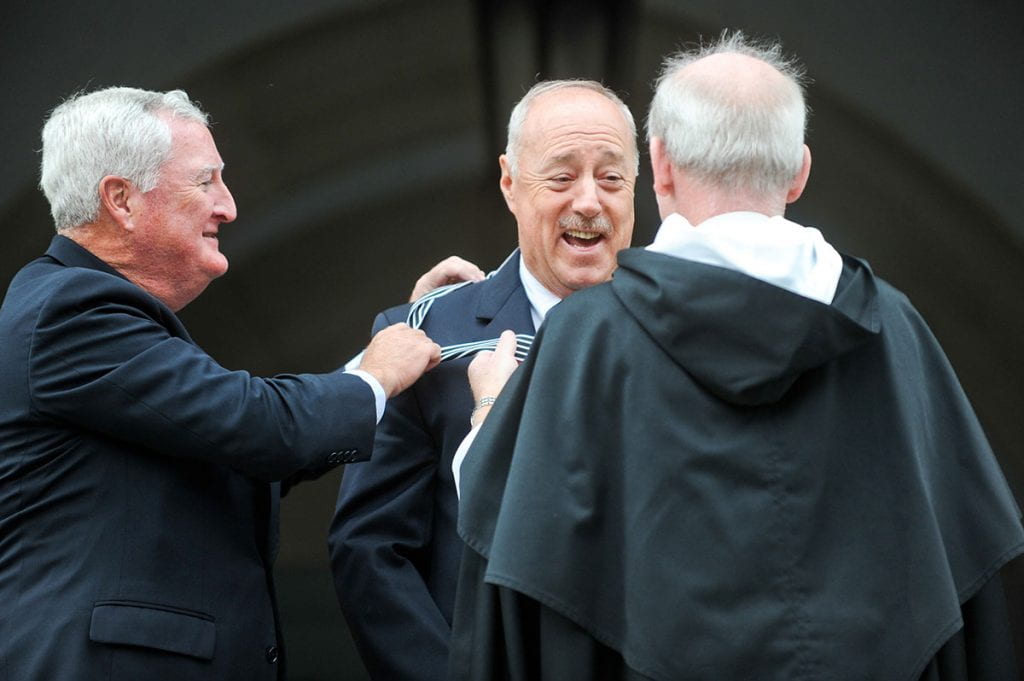Michael A. Ruane ’71 & ’13Hon. laughs as John F. Killian ’77, chair of the Board of Trustees, left, and College President Rev. Brian J. Shanley, O.P. ’80 award him the Veritas Medal during the dedication of the Ruane Center for the Humanities.
