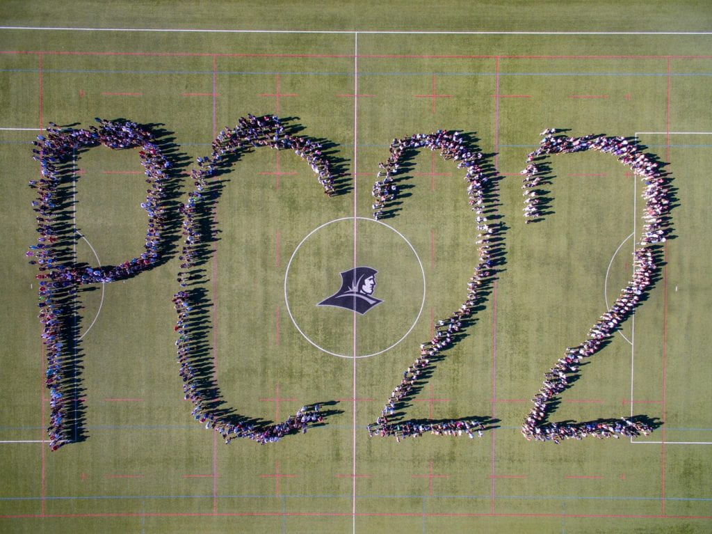 Class of 2022 aerial photo. Students assembled on Hendricken Field to spell out "PC 22."