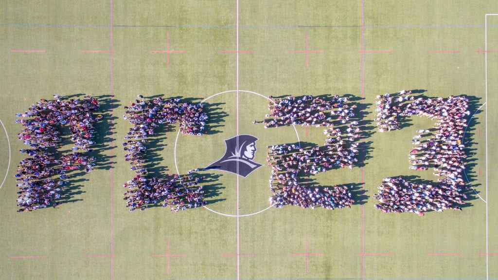 Class of 2023 aerial photo. Students assembled on Hendricken Field to spell out "PC 23."