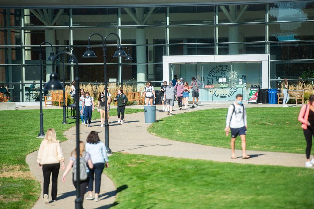 It looks like an ordinary day on the Providence College campus, if not for the masks worn by students heading to and from Slavin Center.