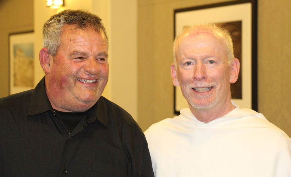 Security Officer Alfred Mansuetti is congratulated by College President Rev. Brian J. Shanley, O.P. '80, during the Service Recognition Dinner at the College in 2019.