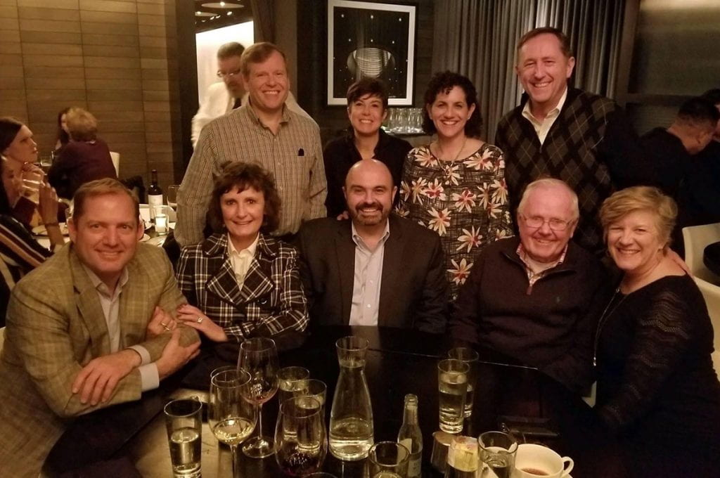 Rev. J. Stuart McPhail, O.P. ’61, second from right in first row, reunited with several Friars two years ago at a dinner in Washington, D.C. Others are, front row from left, James Schenck, Lisa (Thibault) Schenck ’83 & ’18Hon., dinner host Bob Ferreira ’83, PC assistant vice president, special projects and strategic initiatives, Father McPhail, and Jennifer (Alcarez) Smith ’85. Second row: Steve Kunze ’85 & ’12P, Nancy (Cavallero) McNamara ’84, Carole (Ingallinera) Kunze ’86 & ’12P and Tom Smith ’85.