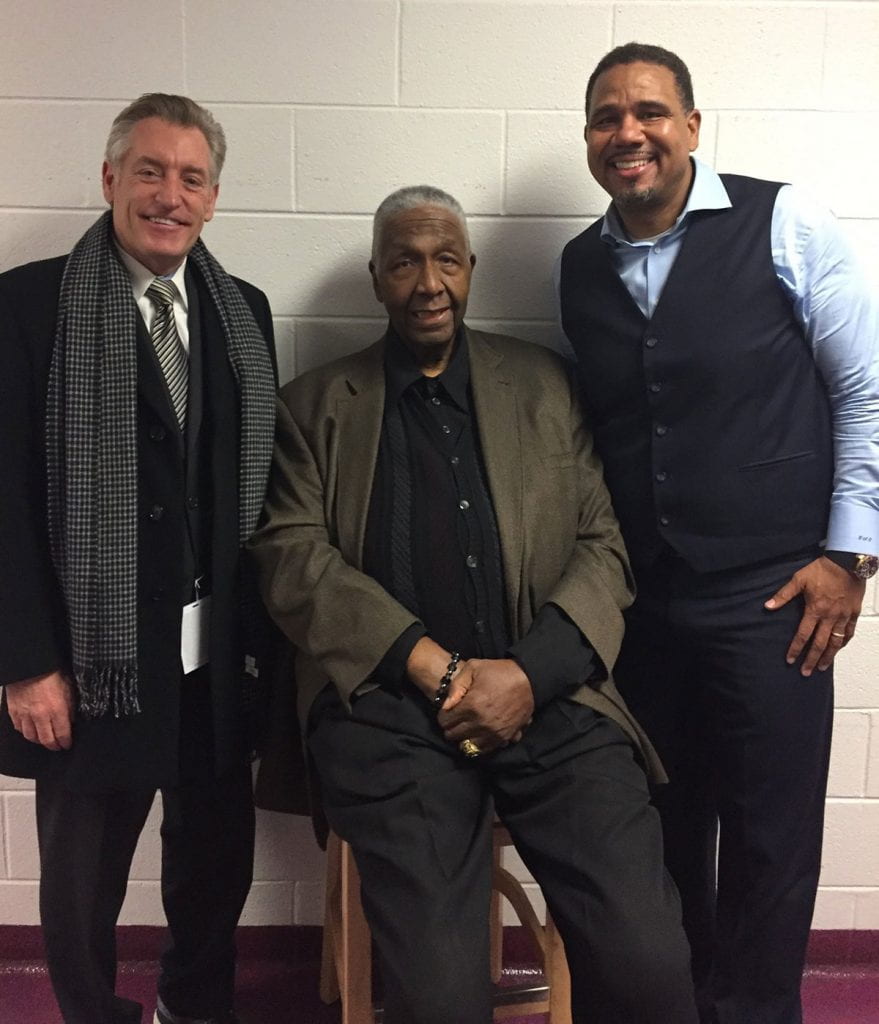 John Thompson Jr. ’64, center, meets with Robert G. Driscoll Jr., PC vice president and athletics director, left, and Friars’ Coach Ed Cooley prior to a PC-Georgetown game at the Dunkin’ Donuts Center a few years ago.