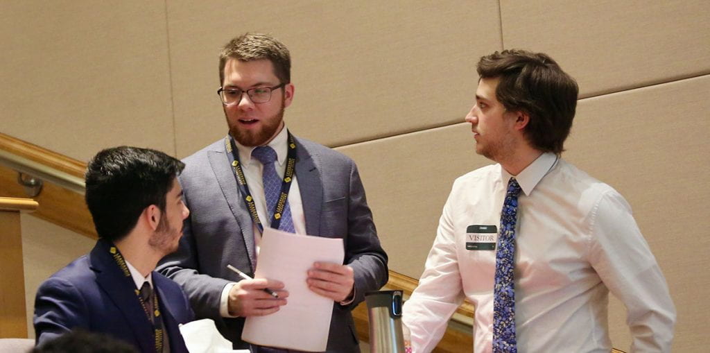 Thomas Heavren ’19, center, takes part in a group exercise on the Clifton Strengths assessment with two College Leadership Rhode Island classmates at Amica Mutual Insurance headquarters in Lincoln, R.I., in December 2019.
