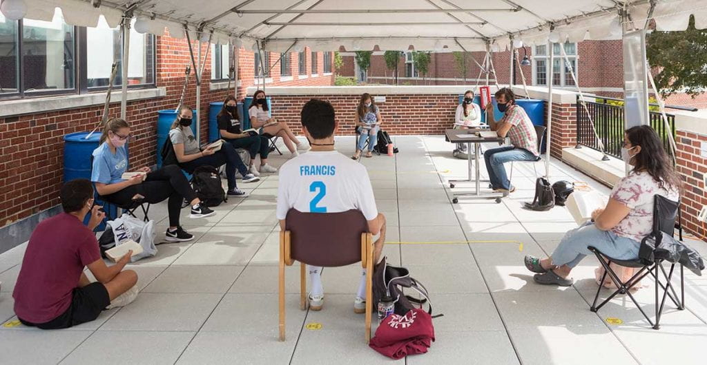 During the fall semester, Dr. Iain Bernhoft, seated at far right, taught a course in the outdoor classroom outside Hickey Hall.