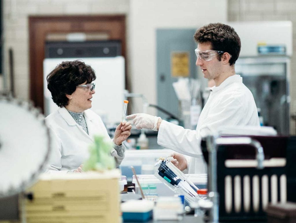 Colby Agostino '22 takes direction from Dr. Kathleen A. Cornely, professor of chemistry and biochemistry, during phage research in her laboratory.