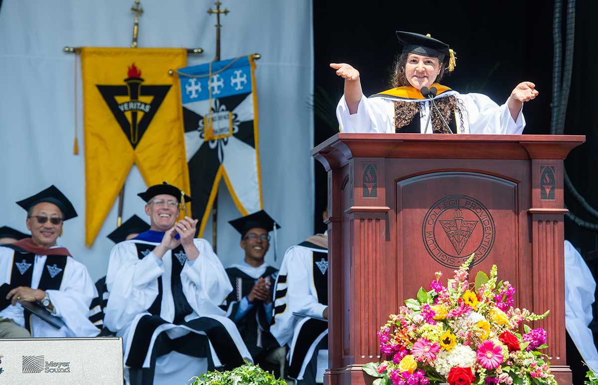 Dr. Laurie Santos, Yale University professor, encourages graduates to stand and acknowledge their friends at the undergraduate commencement ceremony