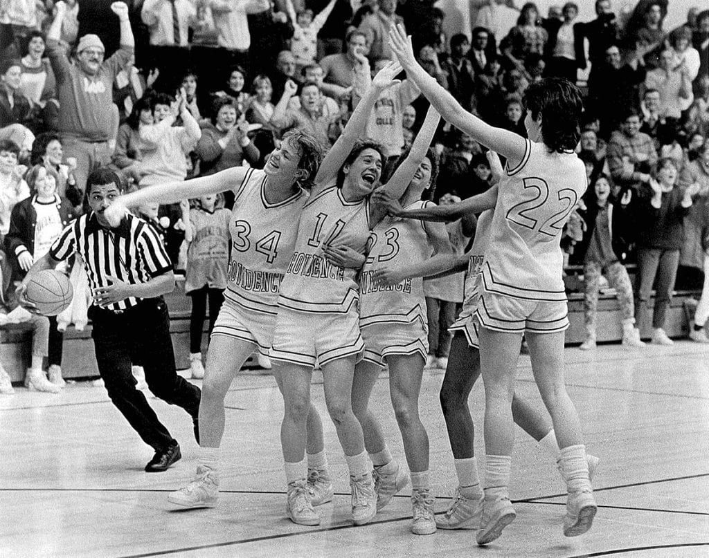 Doris Burke '87, '92G, '05Hon., wearing #11, celebrates with her teammates as the Friars win the BIG EAST regular-season championship at home in 1987, her senior year.
