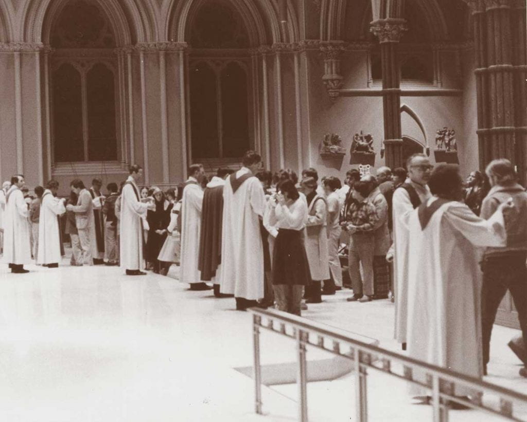Family and friends of the Aquinas Hall fire victims receive Holy Communion during a memorial Mass at the Cathedral of Saints Peter and Paul in Providence on Dec. 18, 1977.