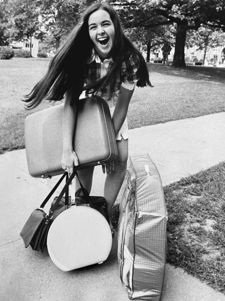 Moving into McDermott Hall as a first-year student in 1972 was memorable for Peggy Martin Weber ’76. A Providence Journal photographer took this photo of her moments after the handle of her sweater bag broke and fell to the ground.