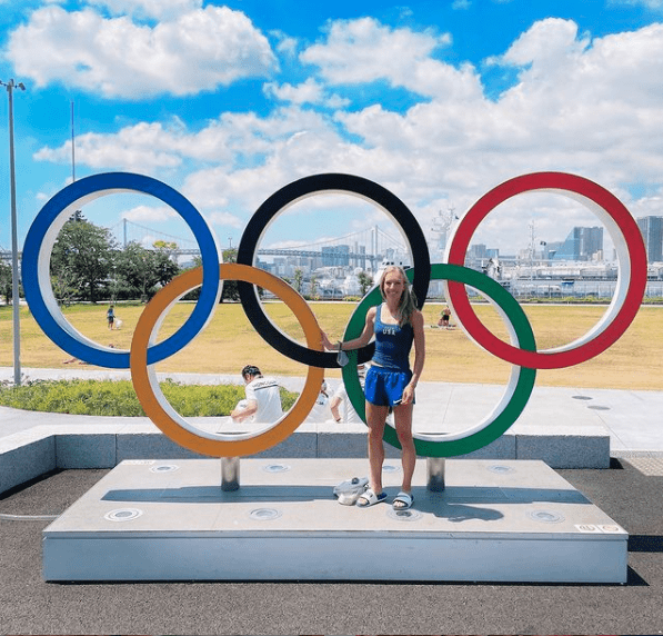 Emily Sisson '14 poses with the Olympic rings at the Tokyo Olympics.