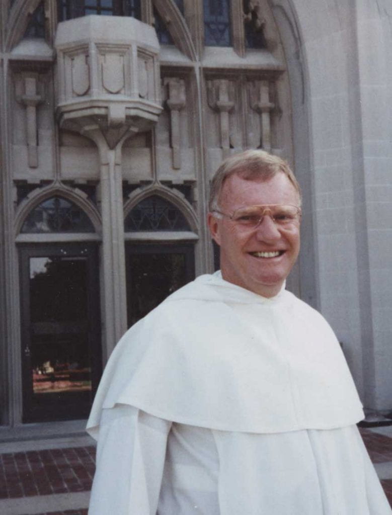 Rev. James F. Quigley, O.P. '60 in earlier days outside Harkins Hall on PC's campus..