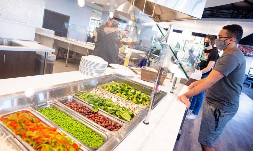 A student checks out the selections at the new salad bar in Raymond Dining Hall.
