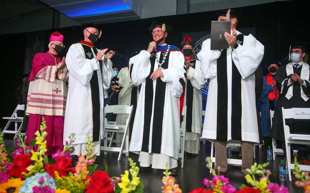 Rev. Kenneth R. Sicard, O.P. '78, '82G, acknowledges the applause of the crowd after being inaugurated as the college's 13th president.