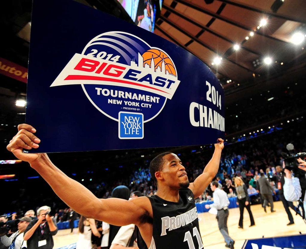 Bryce Cotton '14 hoists the BIG EAST Tournament banner following Providence College's defeat of Creighton University, 65-58, on March 15, 2014. Cotton helped lead the Friars to their first NCAA appearance in 10 years.