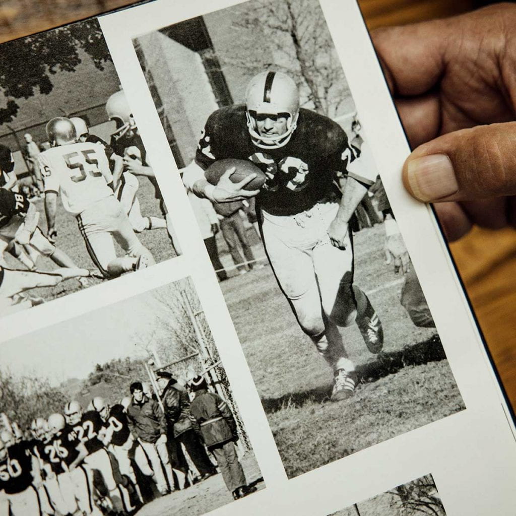 A page from the 1974 Veritas yearbook shows club football captain Richy Kless '74, '78G, '82SCE in action.