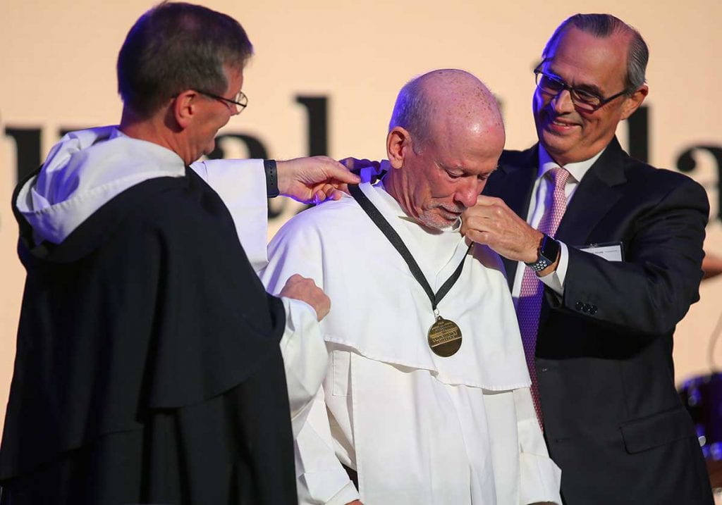 Rev. Brian J. Shanley, O.P. ’80 receives the Veritas Medal from College President Rev. Kenneth R. Sicard, O.P. ’78, ’82G and Trustee Chair Christopher K. Reilly ’84.