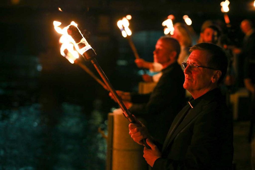 College President Rev. Kenneth R. Sicard, inaugurated the day before, participates in the lighting ceremony at WaterFire.