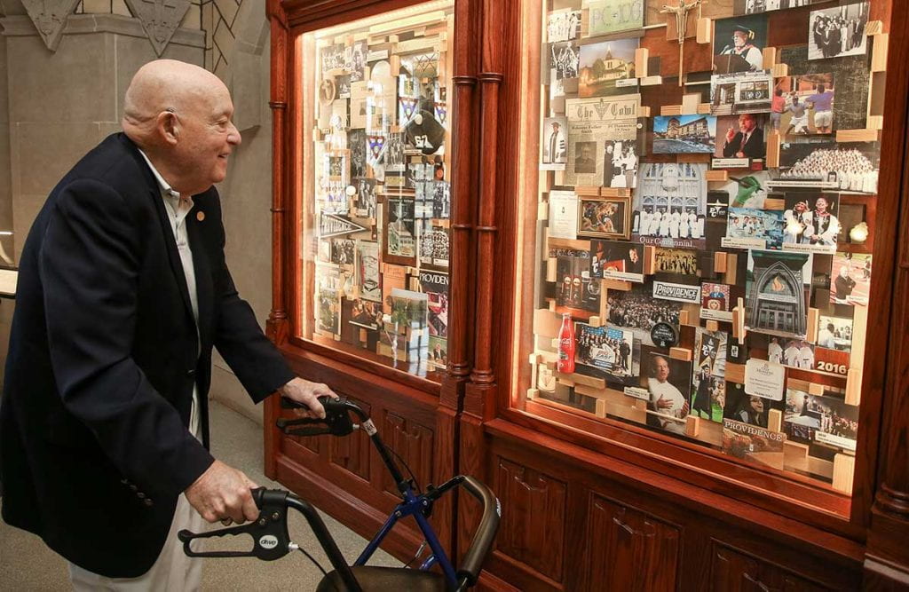 Dr. Joseph Hagan '56 enjoys the Centennial Exhibit in the Harkins Hall rotunda prior to the Golden Friars reunion luncheon in October.