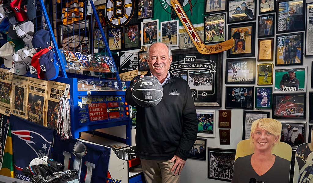 Kerry Rafanelli '80 game room with Friar memorablilia