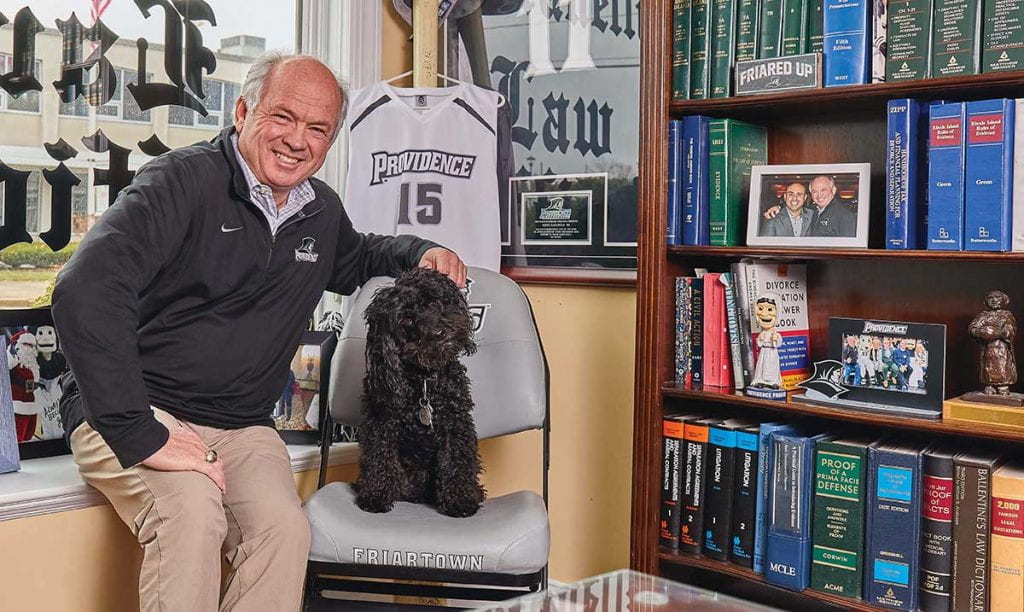 Kerry Rafanelli '80 in his law office with his dog, a black cockapoo named Friar.
