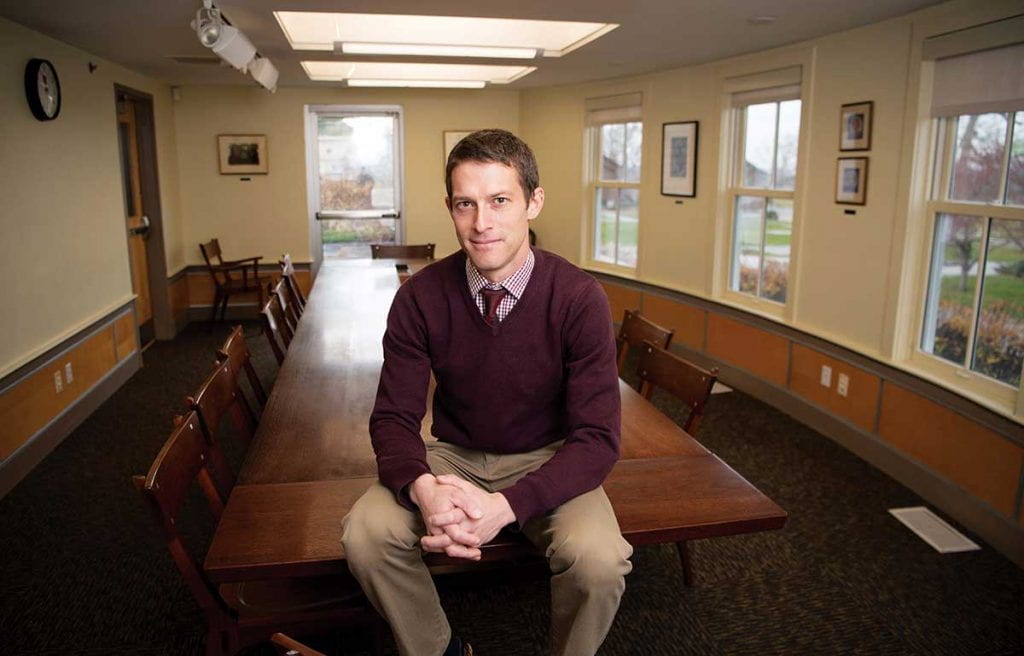 Mike St. Thomas '05 chairs the English Department at the Portsmouth Abbey School in Portsmouth, R.I. He is pictured in his classroom.