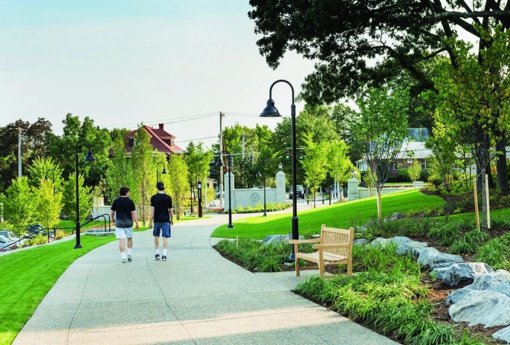 Two students walk toward Eaton Street on the landscaped path that formerly was Huxley Avenue.