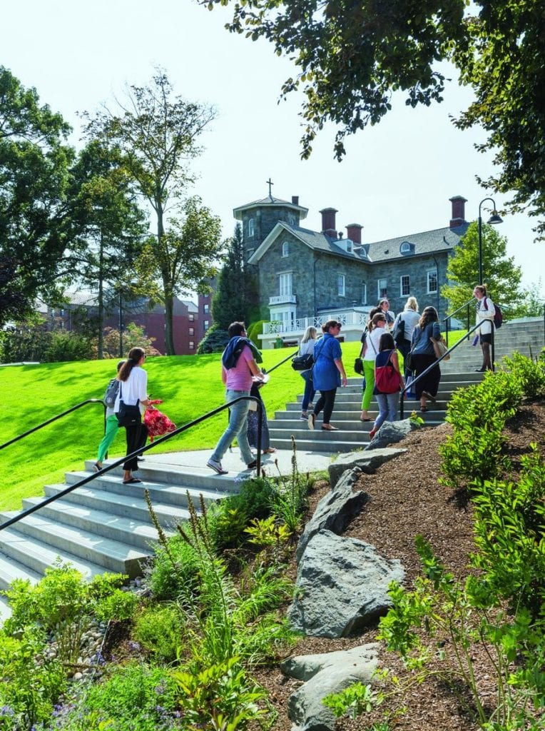 Terraced steps and a ramp have replaced the asphalt walk at Guzman Hill, which runs between Accinno and Guzman halls up to Dominic House. Here, visitors are climbing the stairs during an admission tour.