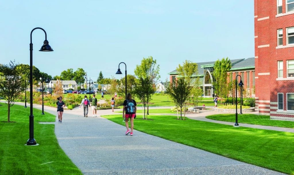 Students walk along landscaped paths near the Arthur F. and Patricia Ryan Center for Business Studies, formerly Dore Hall.