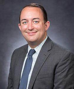 Professional portrait of Owen Bligh ’10, ’14G, senior associate dean of admission.