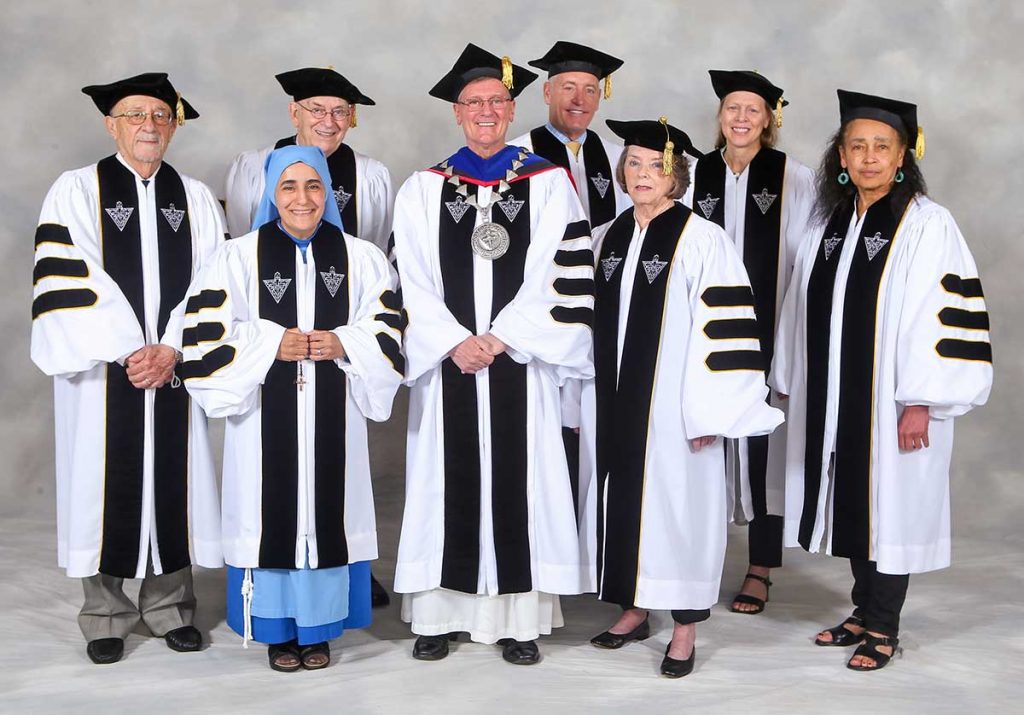 Honorary degree recipients with College President Rev. Kenneth R. Sicard, O.P. '78, '82G and commencement speaker Val Ackerman '20Hon. Back row, from left, Mario DiNunzio, Ph.D. '57; John W. Flynn '61, Father Sicard; Robert G. Driscoll Jr.; Ackerman. Front row, from left, Mother Olga of the Sacred Heart, Sally Thibodeau, Ph.D. '66G.