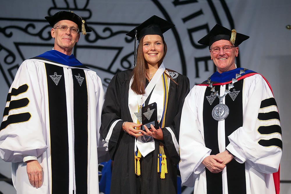 Aisling Maguire '22 at commencement with College President Rev. Kenneth R. Sicard, O.P. '78 & '82G and Provost Sean Reid.