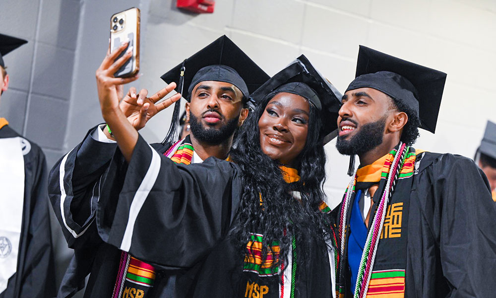 students taking a selfie at commencement
