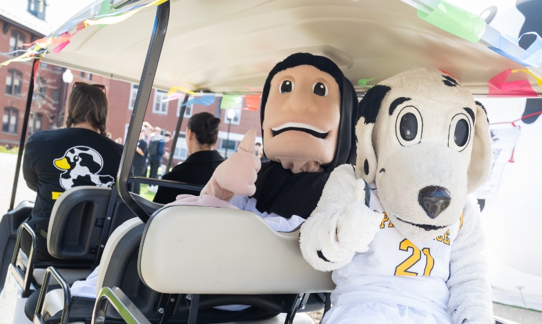 Mascots in a golf cart