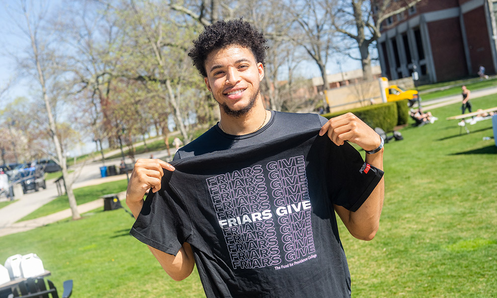 student with friars give t-shirt