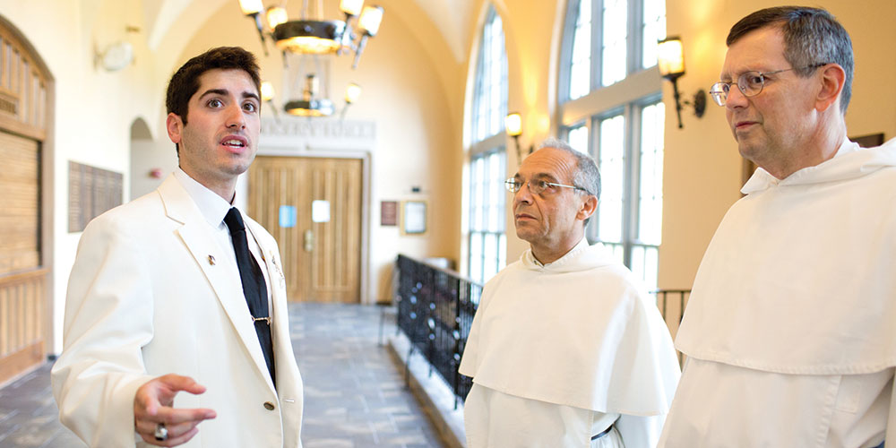 Matthew Santos gives tour of campus to Bruno Cadore, then master of the Dominican Order, in 2014