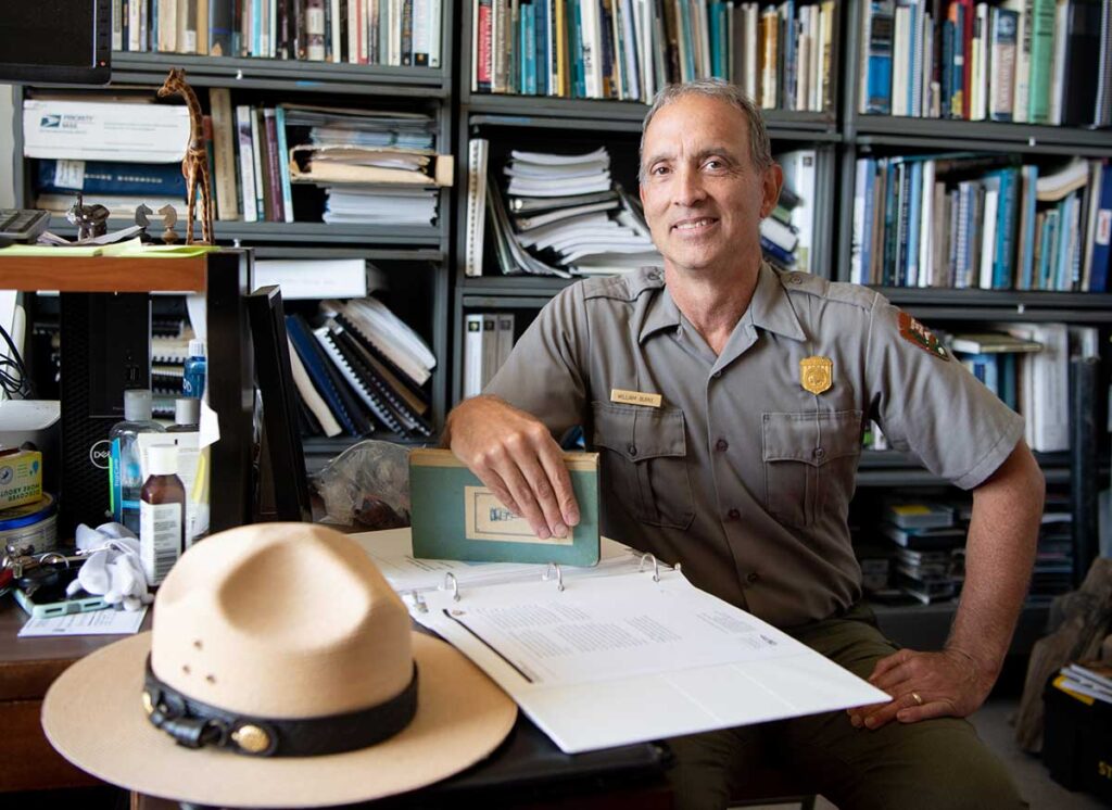 Bill Burke '84 at his desk in the Salt Pond Visitor Center in Eastham, Mass. In a room under the center, he handles artifacts and processes primary data.