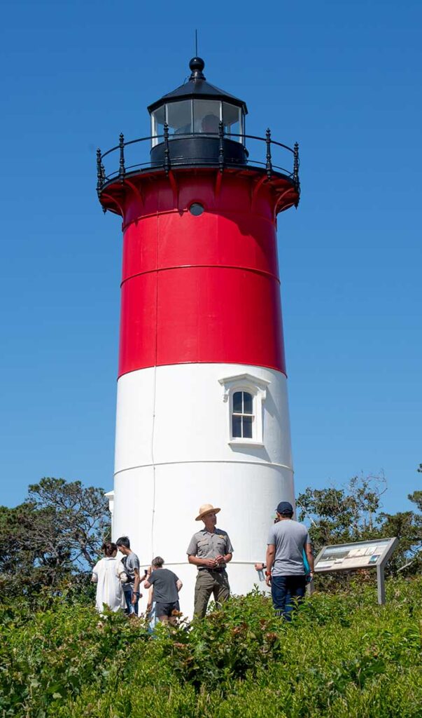 Bill Burke '84 leads a tour outside Nauset Light, one of Cape Cod's best-known landmarks (you might recognize it from the Cape Cod Potato Chip bag). The tower dates to 1877 and was originally Chatham Light. It was relocated to its current site and restored in 1923. It is listed on the National Register of Historic Places.