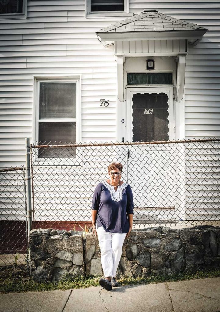 Providence District Court Judge Melissa Dubose '90 poses outside her childhood home in the Mount Hope neighborhood of Providence.