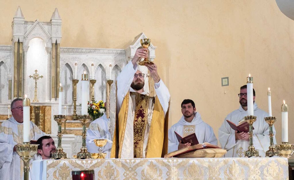 Rev. Damian Marie Day, O.P. '15 celebrates Mass for the first time on May 22, 2022, at St. Peter's on Capitol Hill in Washington, D.C. At far right is Rev. Jordan Zajac, O.P. '06.