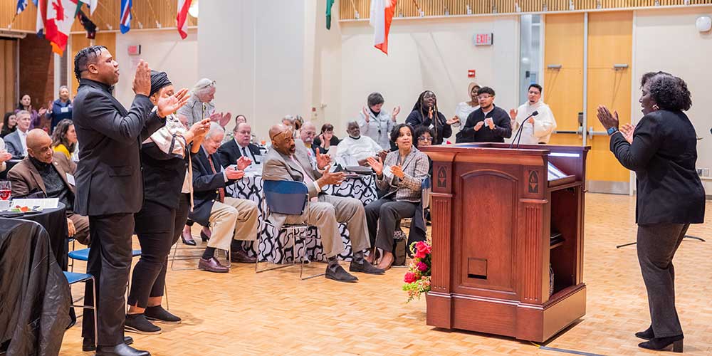 Rev. Lauri Smalls leads the gathering in song